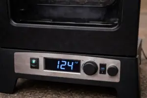 Electric smoker digital display showing temperature rising during preheat